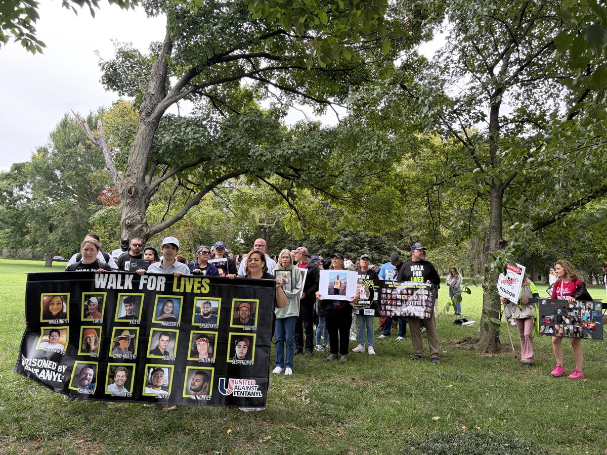 Families gather beside a memorial board of loved ones on the National Mall
